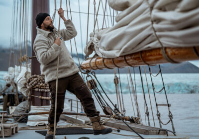 Noorderlicht Guest pulling ropes onboard tall ship Svalbard